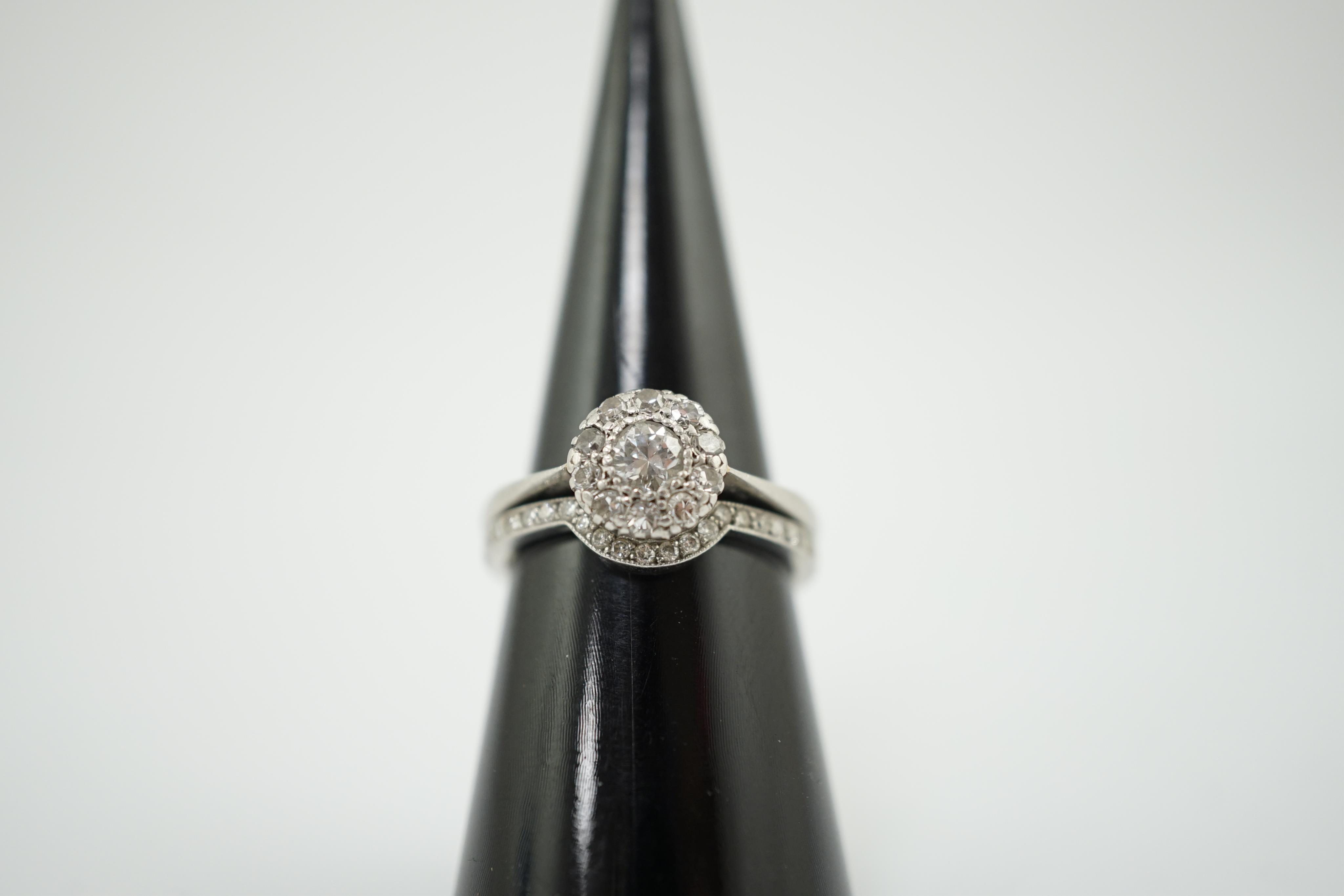 A mid 20th century and later platinum and diamond matched two piece wedding set
